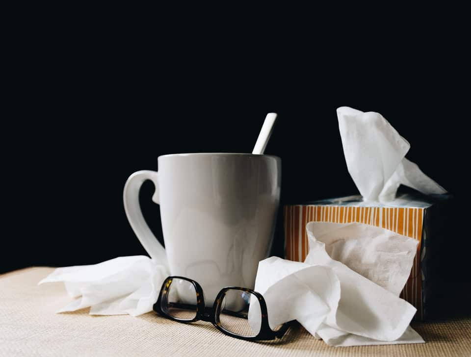 A mug, a pair of glasses and some tissues.