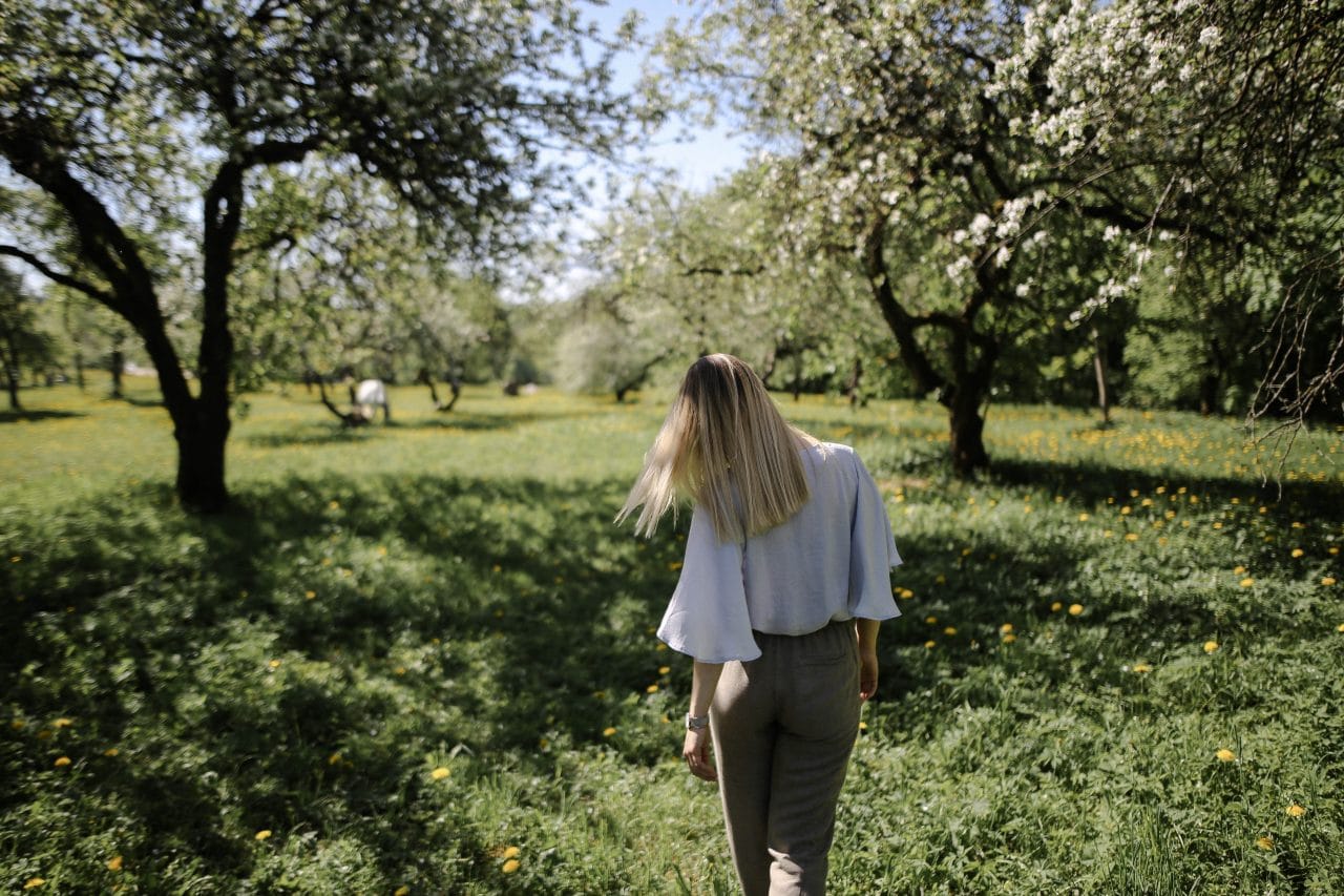 Woman walking out in nature in the springtime.